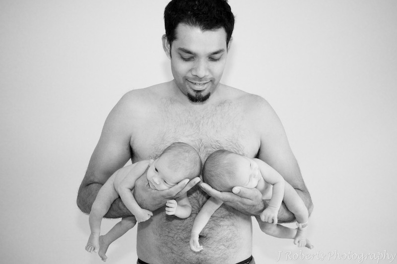 B&W dad holding newborn baby twins - baby portrait photography sydney